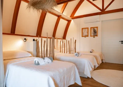 Bedroom with 3 beds of the Te Moana bungalow at the Tiki Beach in Moorea